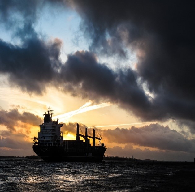 A cargo boat carrying tankers on the ocean