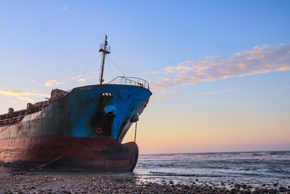 An old ship anchored to the shore